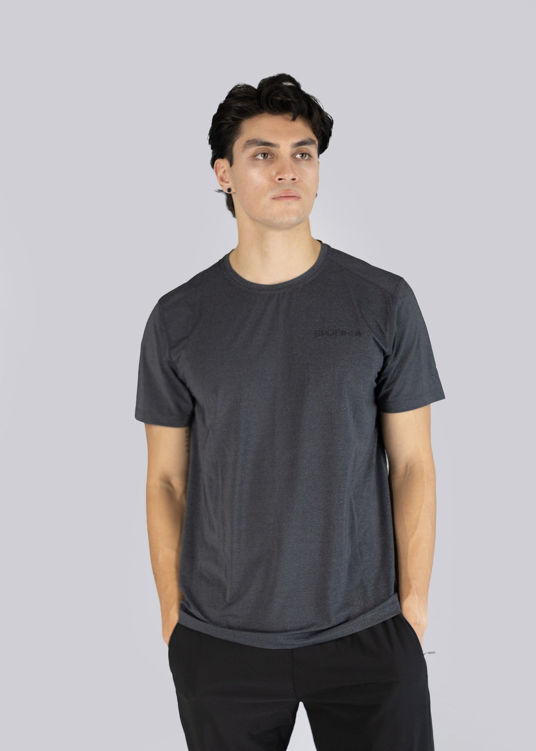 Man wearing a dark gray t-shirt with the Spofire logo on a light gray background