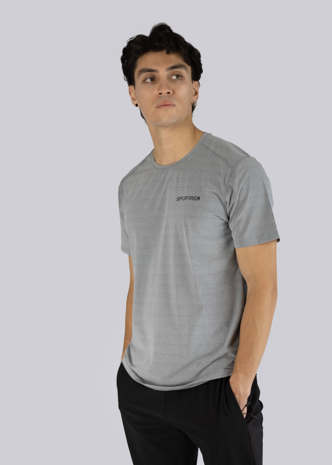 A man wearing a gray t-shirt with the Spofire logo on a plain background